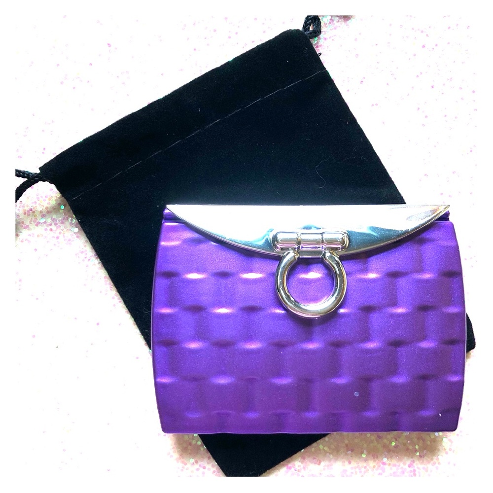 Purple compact mirror is double sided.